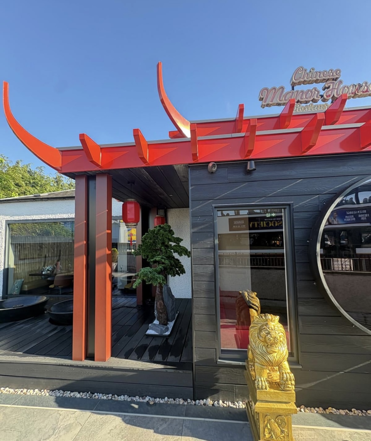 Bespoke fabricated red metal pagoda canopy and trims on the Chinese Manor House restaurant frontage